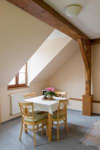 a dining room with a white table and chairs at Apartmany A.Ša Kašperské Hory in Kašperské Hory