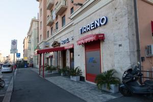 a store with a sign on the side of a building at Hotel Tirreno in Genoa