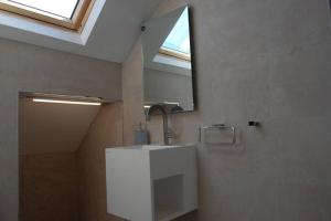 a bathroom with a sink with a mirror and a window at Soofi House in Sheffield +16 photos