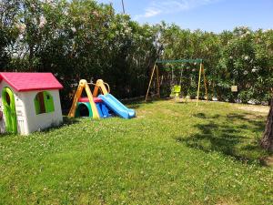 a group of playground equipment in the grass at Posto Nove Country House in Corropoli