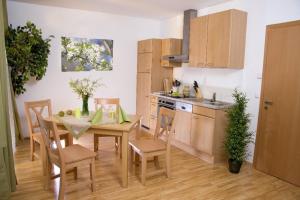 a kitchen and dining room with a table and chairs at Gasthof Spengerwirt in Hirschegg Rein