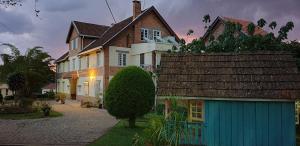 a large house with a blue garage in front of it at Lovasoa 4C in Antsirabe