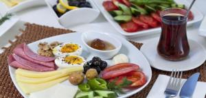 a plate of food with eggs and vegetables on a table at Happy Night Hostel in Wadi Musa