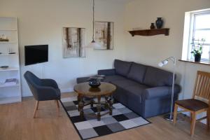 a living room with a couch and a table at Mosborg in Ulfborg