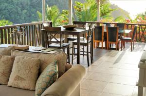 a living room filled with furniture and a patio at Marigot Beach Club & Dive Resort in Marigot Bay