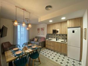 a kitchen and dining room with a table and a refrigerator at EL HOSPEDAJE DEL REY in Trujillo