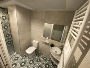 a small bathroom with a toilet and a sink at EL HOSPEDAJE DEL REY in Trujillo +12 photos