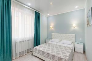 a bedroom with a bed and a large window at Home-otel in Krasnodar