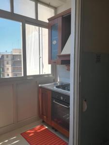 a kitchen with a stove top oven next to a window at Casa di Angela in Syracuse