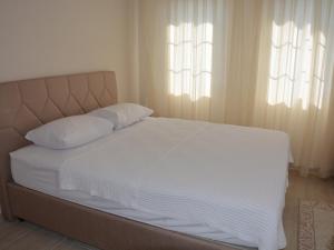A bed or beds in a room at Konak Sari