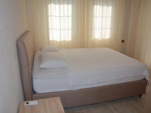 A bed or beds in a room at Konak Sari