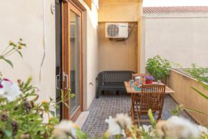 a small patio with a table and a bench at Case Fiorite in Riola Sardo