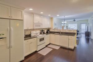 a large kitchen with white cabinets and appliances at Indian Rocks Beach Harbourside - Waterpark in Clearwater Beach