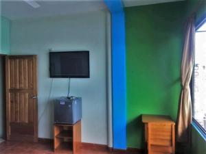 a room with a flat screen tv on a wall at Amazon Dream House with AC and Starlink in Iquitos