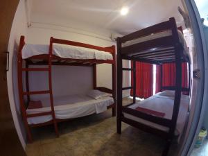 a room with two bunk beds and a mirror at Backpack Lanka in Colombo