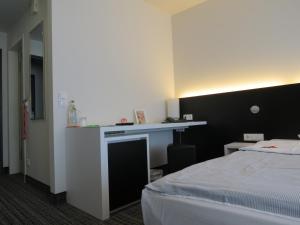 Postel nebo postele na pokoji v ubytování Comfor Hotel Ulm City