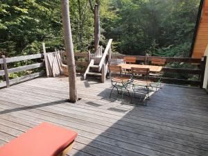 a wooden deck with a table and chairs on it at Cabana Crenguta in Sibiu