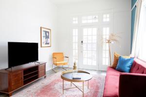 a living room with a tv and a couch and a table at Sonder at Viewpoint in New Orleans