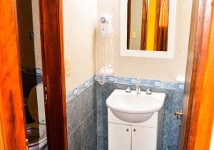 ein Badezimmer mit Waschbecken und Spiegel in der Unterkunft Cabañas Brisas del Cerro in Los Reartes + 48 Fotos