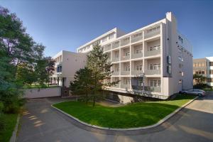 an apartment building with a car parked in a parking lot at Hotel Apartman Student in Prague