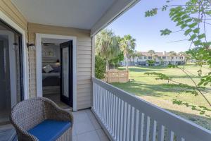 a porch with a wicker chair and a bedroom at La Casa Del Mar 610 Star5Vacations in Dunedin