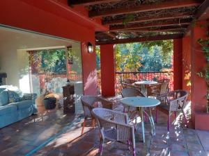 a patio with tables and chairs and a couch at Casa rural Entreaguas in Villanueva de la Vera