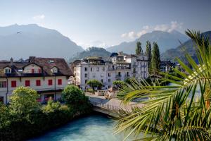 a city with a bridge over a river with buildings at Alplodge in Interlaken