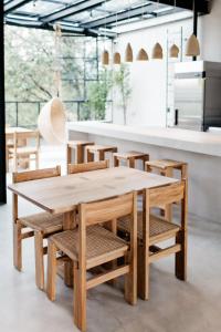 a wooden table and chairs in a room with a counter at Casa Pancha in Mexico City