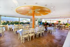 a restaurant with tables and chairs and a large clock on the ceiling at White House Hotel Istanbul in Istanbul
