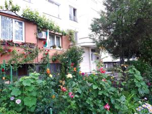 a garden in front of a building with flowers at New York - guest room near the Airport, transport possibility in Sofia