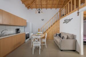 a kitchen and living room with a couch and a table at Anastasia house in Halki