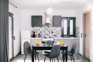a kitchen with a table and chairs in a room at Volos Suites Center in Volos