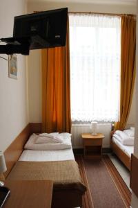 a hotel room with a bed and a window at Hotel Europejski in Przemyśl