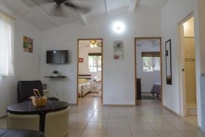 a living room with a couch and a table in a room at Entre Dos Aguas in Coyuca