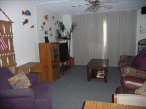 a living room with two couches and a table at Florence I Condos F1705 in South Padre Island