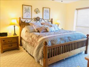 a bedroom with a bed and two lamps and a window at Saida IV Condos S4308 in South Padre Island