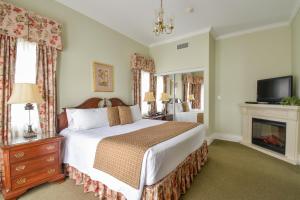 a bedroom with a large bed and a fireplace at The Waring House in Picton