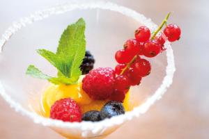 a bowl of fruit with berries in it at Hotel Haus Delecke in Möhnesee