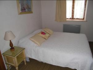 En eller flere senge i et værelse på Domaine du Breuil