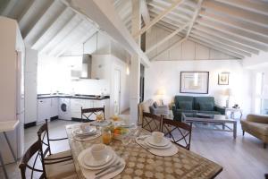 a dining room and living room with a table and chairs at Apartamento Mar de Alborán in Málaga