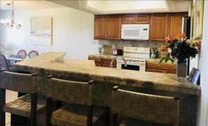 a kitchen with a large stone island in the middle at Suntide I Condos W102 in South Padre Island