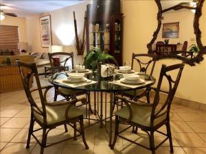 a dining room with a glass table and chairs at Saida IV Condos S4308 in South Padre Island