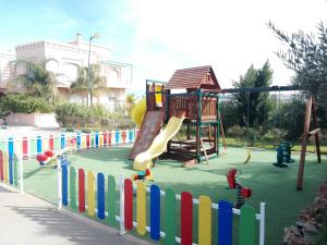 a playground with a slide in a park at Villa Fatima in Meknès