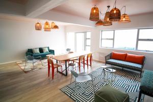 a living room with a dining room table and chairs at CURIOCITY Green Point in Cape Town