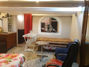 a room with a bed and a table in it at La Casa di Daniele in Brescia