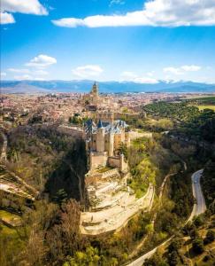 an aerial view of a city with a castle at Hostal Juan Bravo in Segovia +78 photos