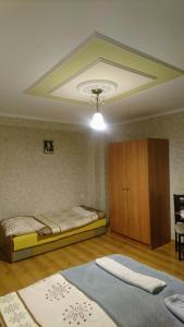 a bedroom with two beds and a ceiling at Apartament Frezja in Tylicz