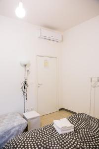 a white room with two beds and a door at Interno 7, tra la Fiera ed il Centro in Bologna