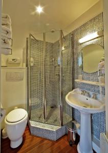 a bathroom with a shower and a toilet and a sink at Logis Hôtel La Chaize in Noirmoutier-en-l'lle