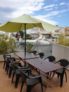 a table and chairs with an umbrella on a patio at casa con amarre privado ref 214 in Empuriabrava
